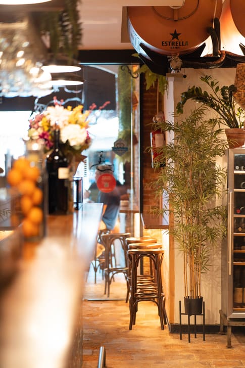 The bar at L'Aixeta Sitges, with fresh flowers and street light in the background