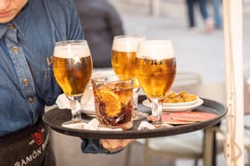 A tray of beers, vermouth and olives